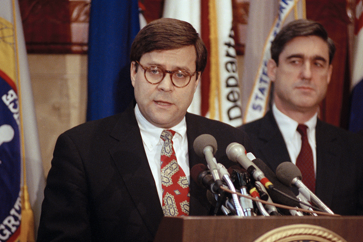 Then-Attorney General William Barr addressing reporters in Washington in 1991, as then Assistant Attorney General Robert Mueller stands nearby.