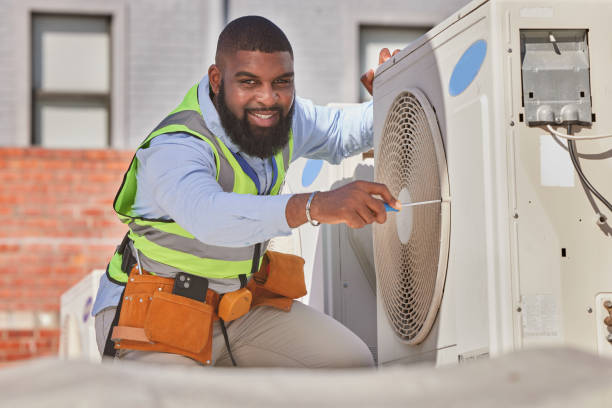 Technician working on commercial HVAC rooftop unit