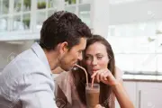 28071745-close-up-of-a-loving-young-couple-sharing-a-drink-at-home
