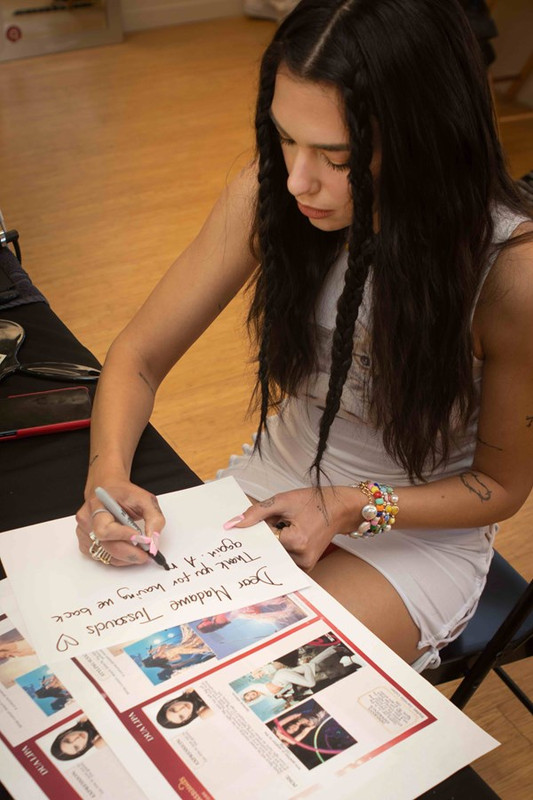 dua-lipa-sitting-signing