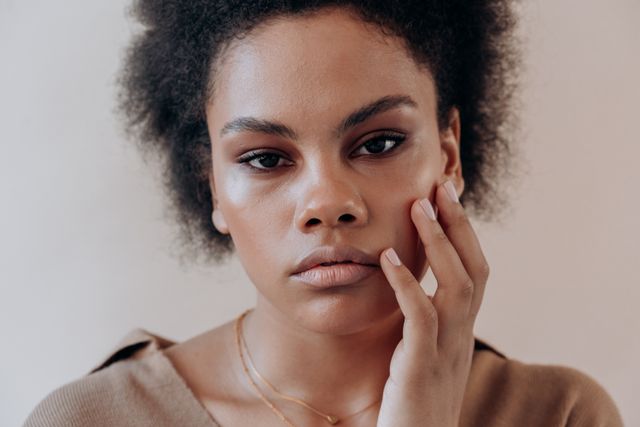 a woman with dehydrated skin that can make her makeup look dull, uneven and patchy 