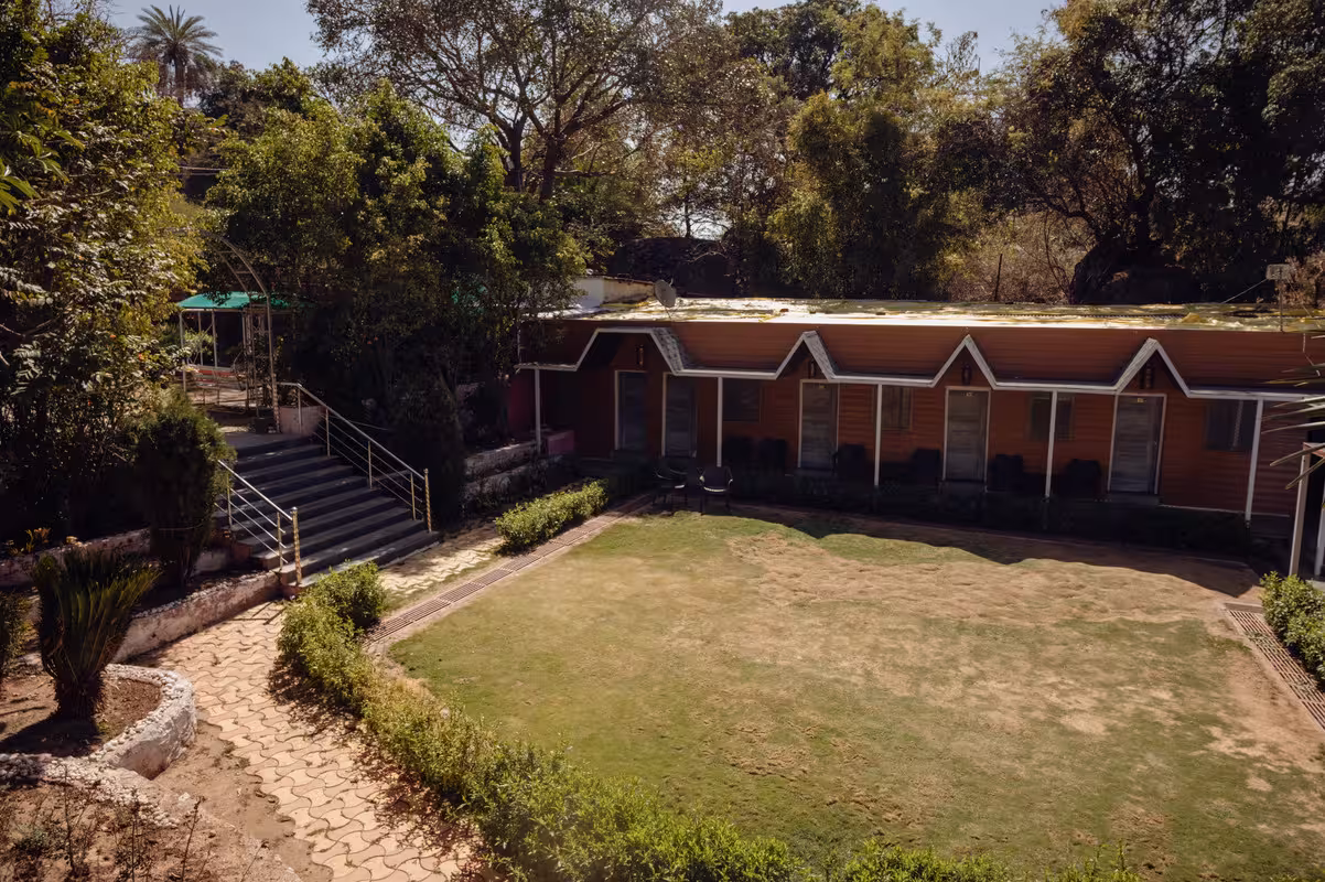 Lush green gardens and serene exterior of Ajanta Resorts in Mount Abu