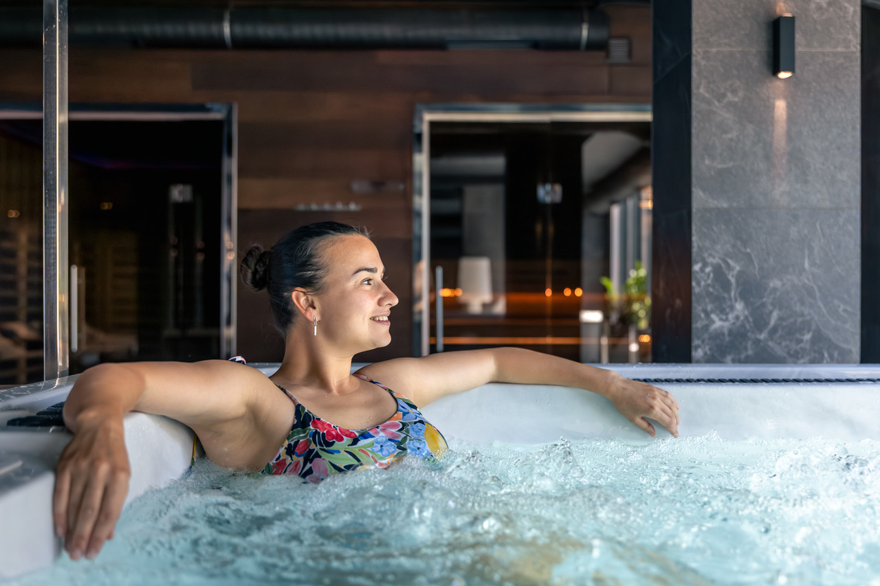 woman enjoying hydromassage hot tub urban spa easy pause