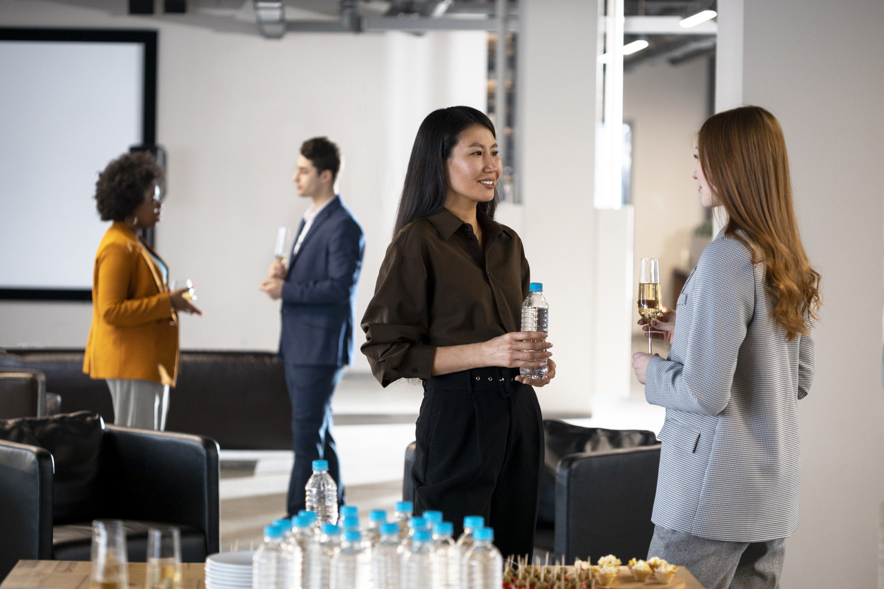 close up smiley women chatting company event