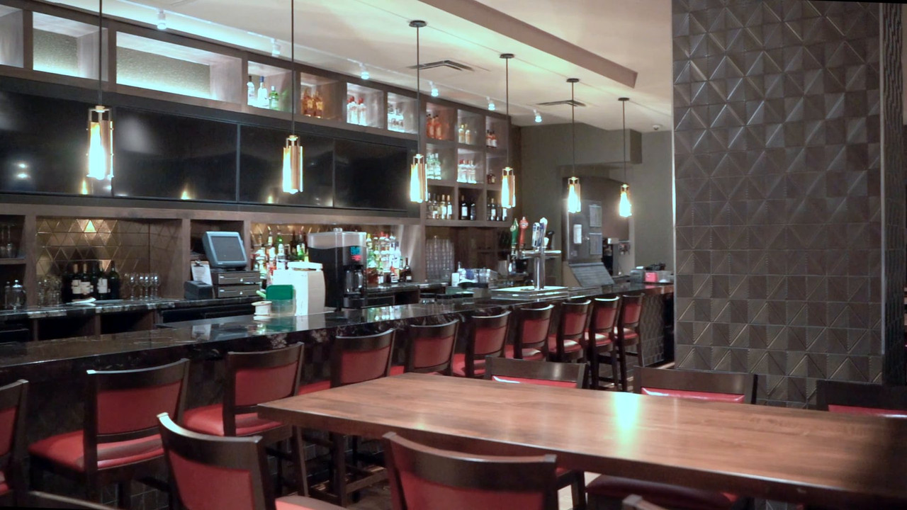 Hard Rock Cafe bar with red stools and pendant lights