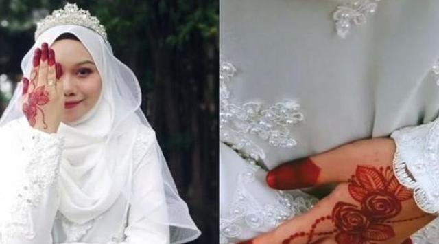 Yana mengenakan gaun pengantin berwarna putih dengan tangan yang dilukis dengan hena
