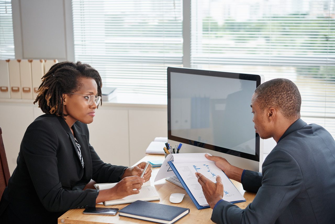 Executive professional in discussion with a senior leader
