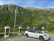 Tesla parked in a scenic European location