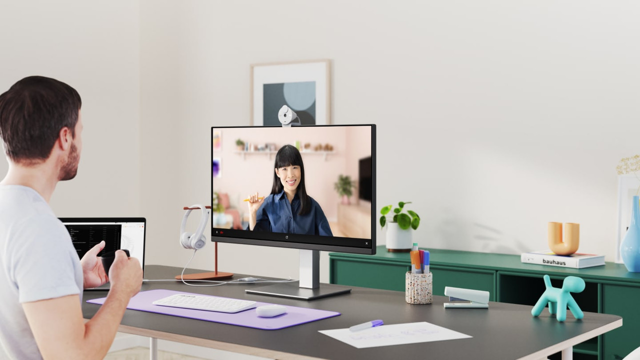 Cámara web Logitech Brio 300 en un escritorio, mostrando su diseño cónico.