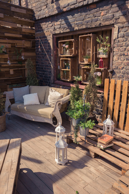 Rustic Balcony Design with Exposed Red Brick Wall and Greenery