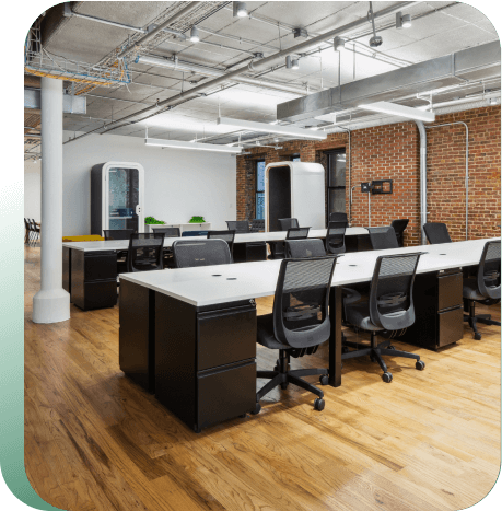 Rows of desks and chairs lined up against window.