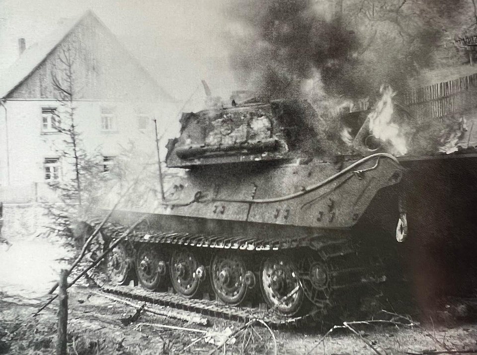 A burning Tiger II (with pre production turret!!)of Schwere Panzer Abteilung 506 blocks the road in 