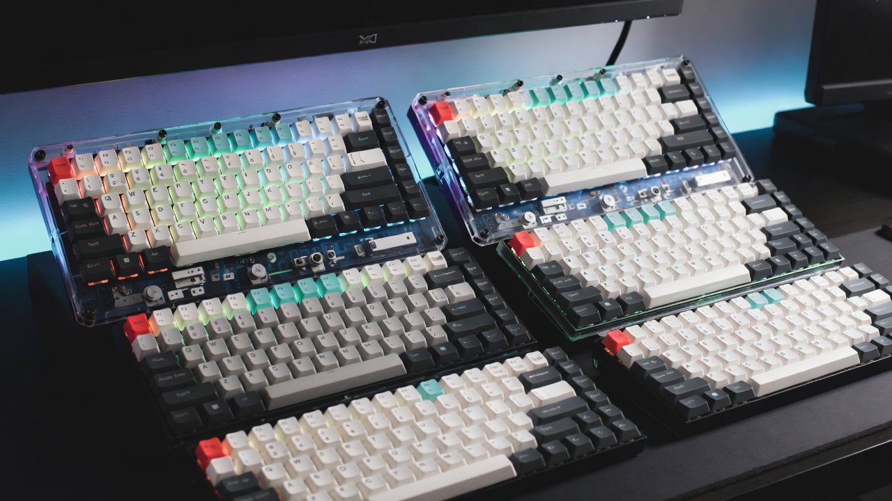 Selection of top-rated mechanical keyboards lined up on a desk showing different form factors and RGB lighting