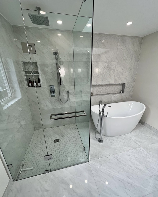 Finished shower with ceiling rain head and freestanding tub
