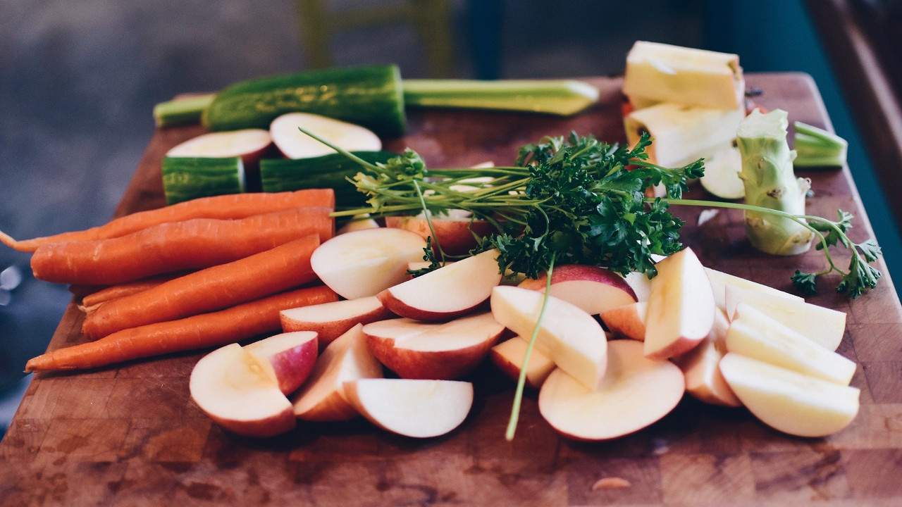 Chopped fruits and vegetables on a cutting board.