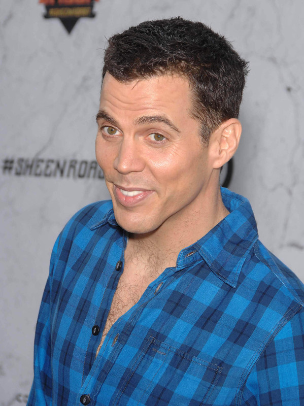 Cabelo castanho escuro e penteado chique de Steve-O  em 2024