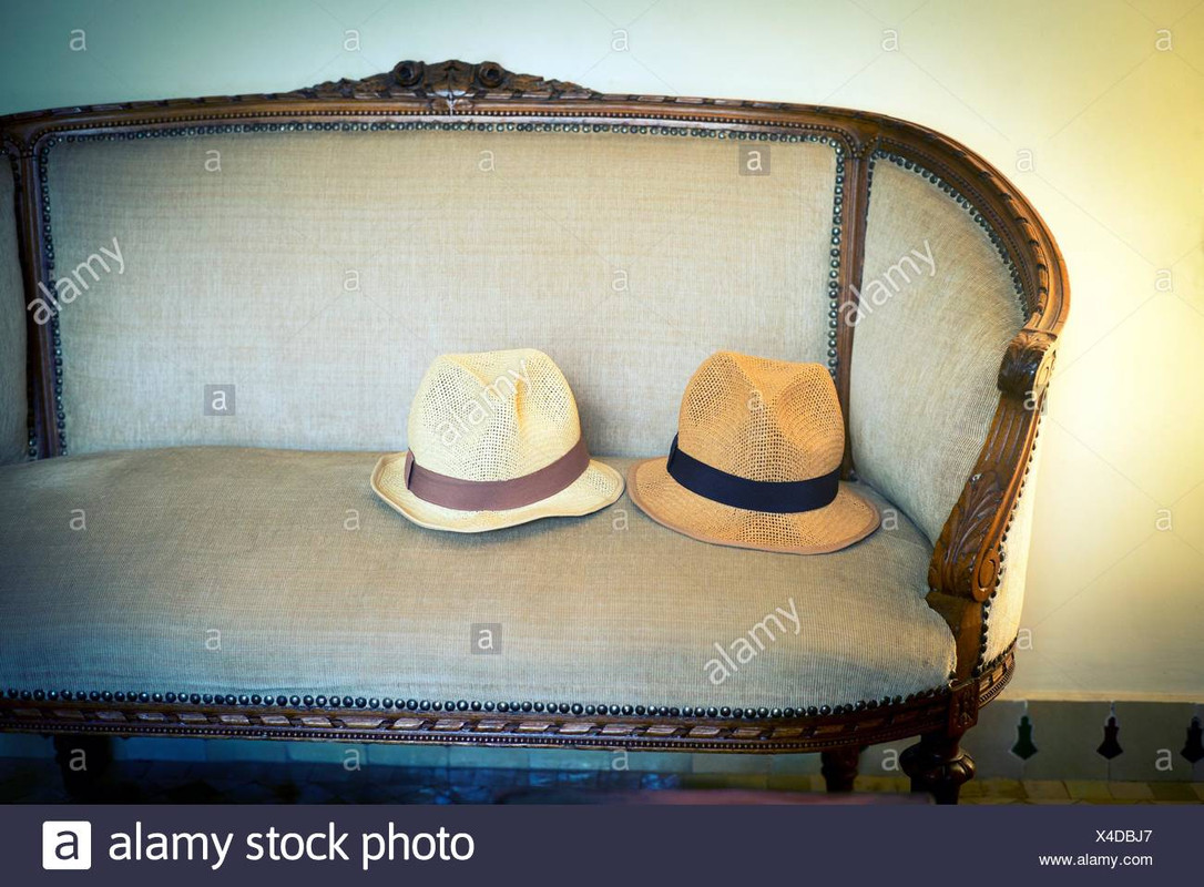 two-hats-on-a-living-room-sofa-fez-morocco-africa-X4DBJ7