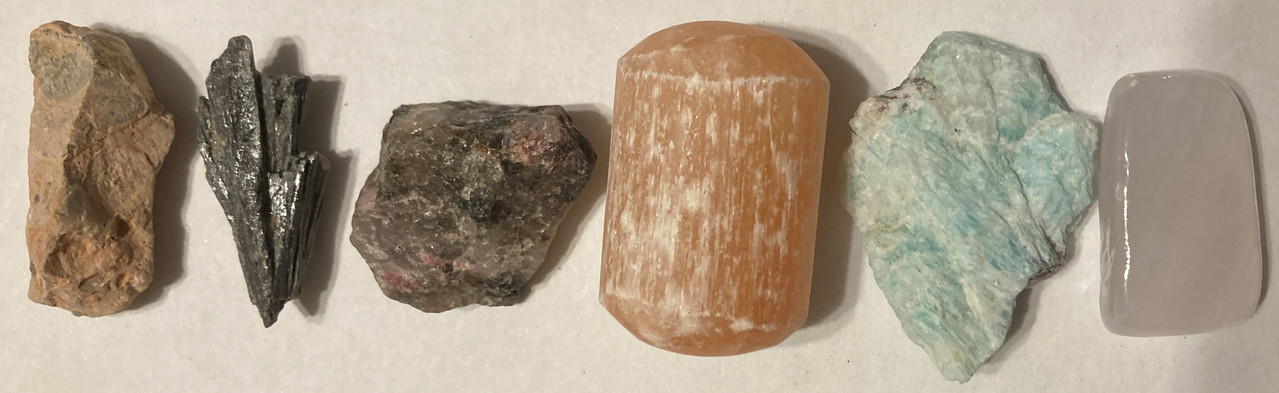 Raw Leopard jasper, raw black kyanite, raw rhodonite, tumbled orange selenite, raw amazonite, tumbled pink calcite, mystery gift, 15ml Harmony Oil, information sheet