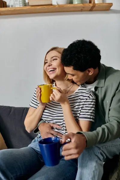 stock-photo-young-multicultural-couple-laughs-enjoys-good-morning-modern-apartment