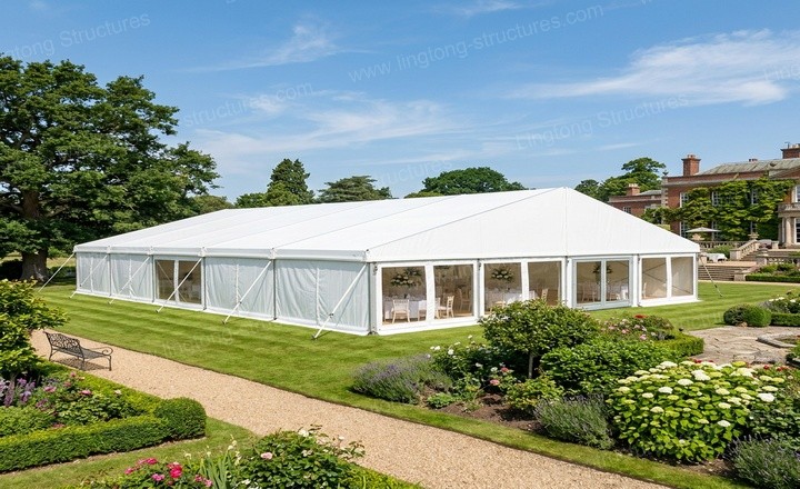 Wedding marquee exterior view showing the elegant white frame and PVC cladding in the Provence estate setting