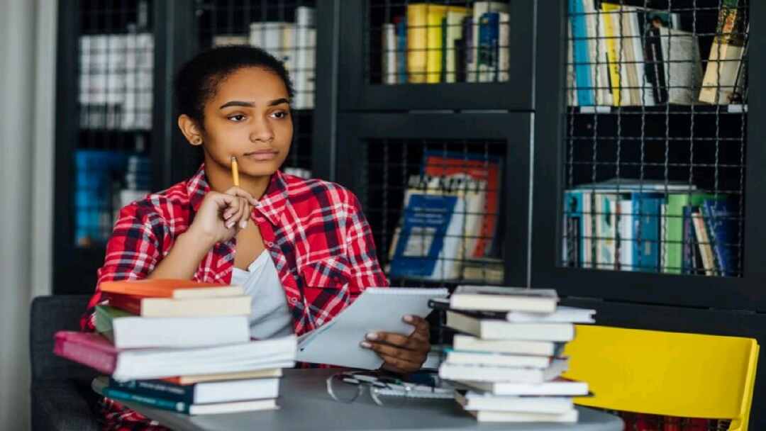 Young Student Sitting University Library Break From Studying.