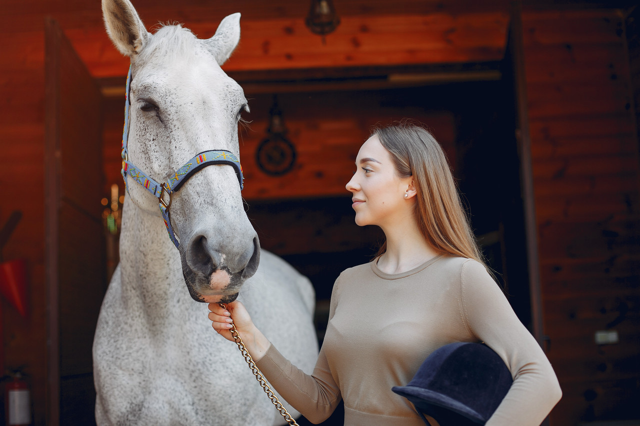 beautiful woman standing with horse