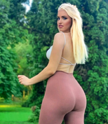 Chanel Cazzaniga, a beautiful young blonde fit woman in pink leggings, poses gr