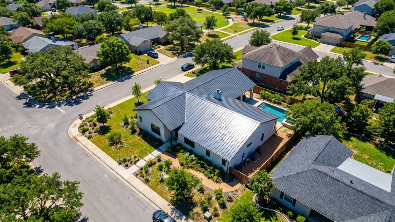 Standing seam metal roof reflecting sunlight on a San Antonio home