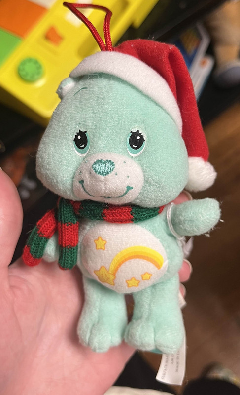 A small mint-green bear plush ornament