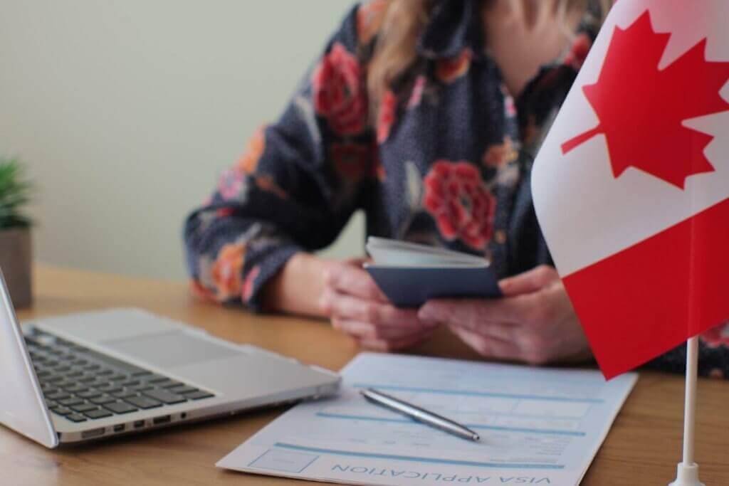 Person completing Canadian legal documents at a desk