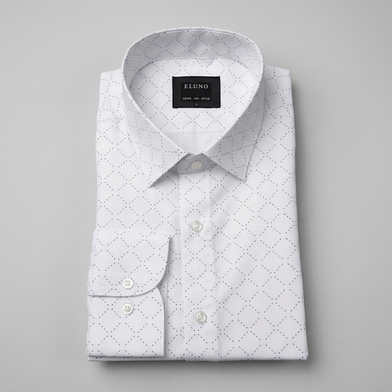 Man in a crisp light pink dress shirt with white collar and cuffs