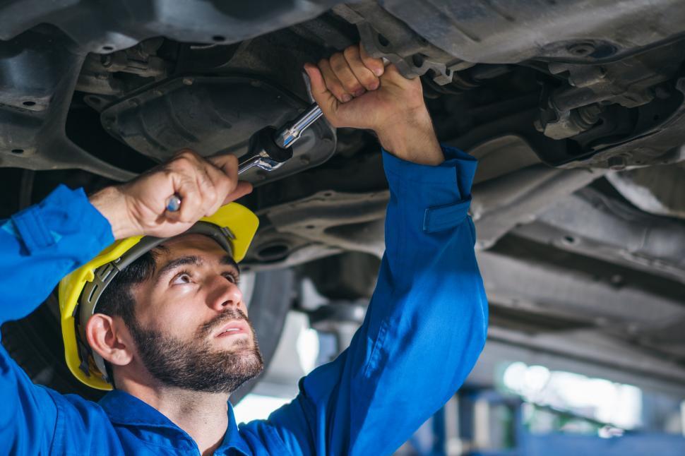 mechanic-repairing-car-damage-at-auto-sh