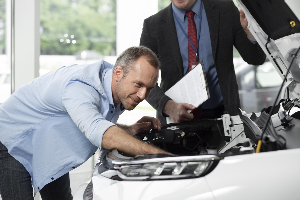 close-up-customer-with-business-person-car-dealership-1