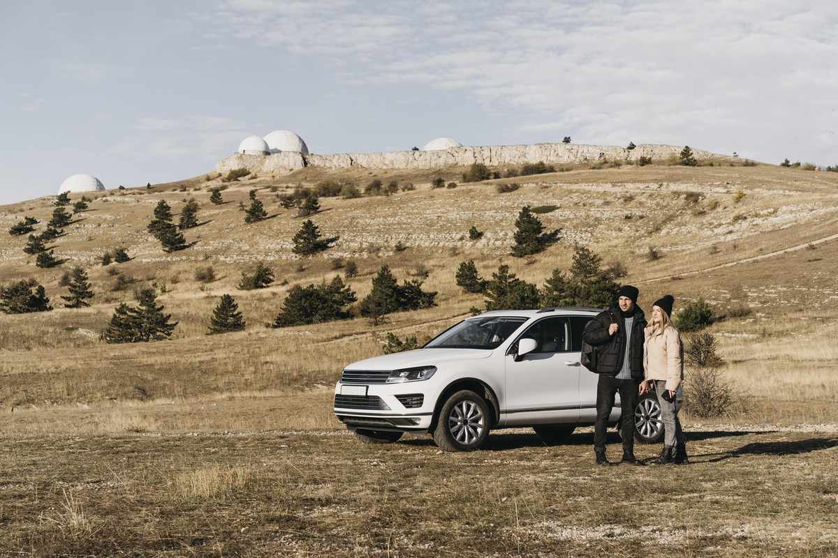 full-shot-couple-near-car-1