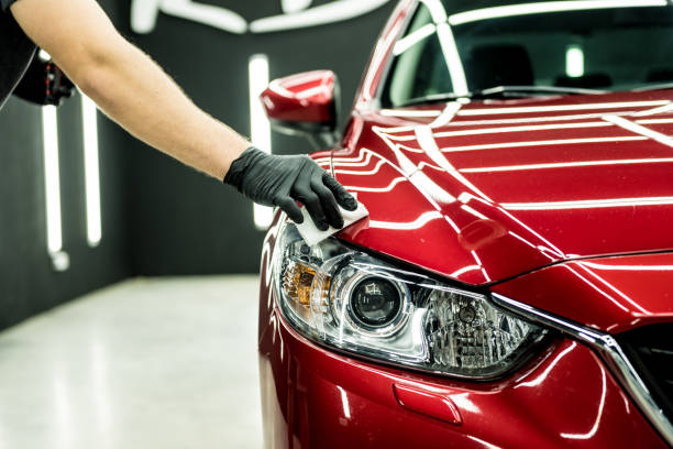 car-service-worker-applying-nano-coating-on-a-car-detail.jpg