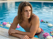 Man-resting-on-pool-edge-202605111904