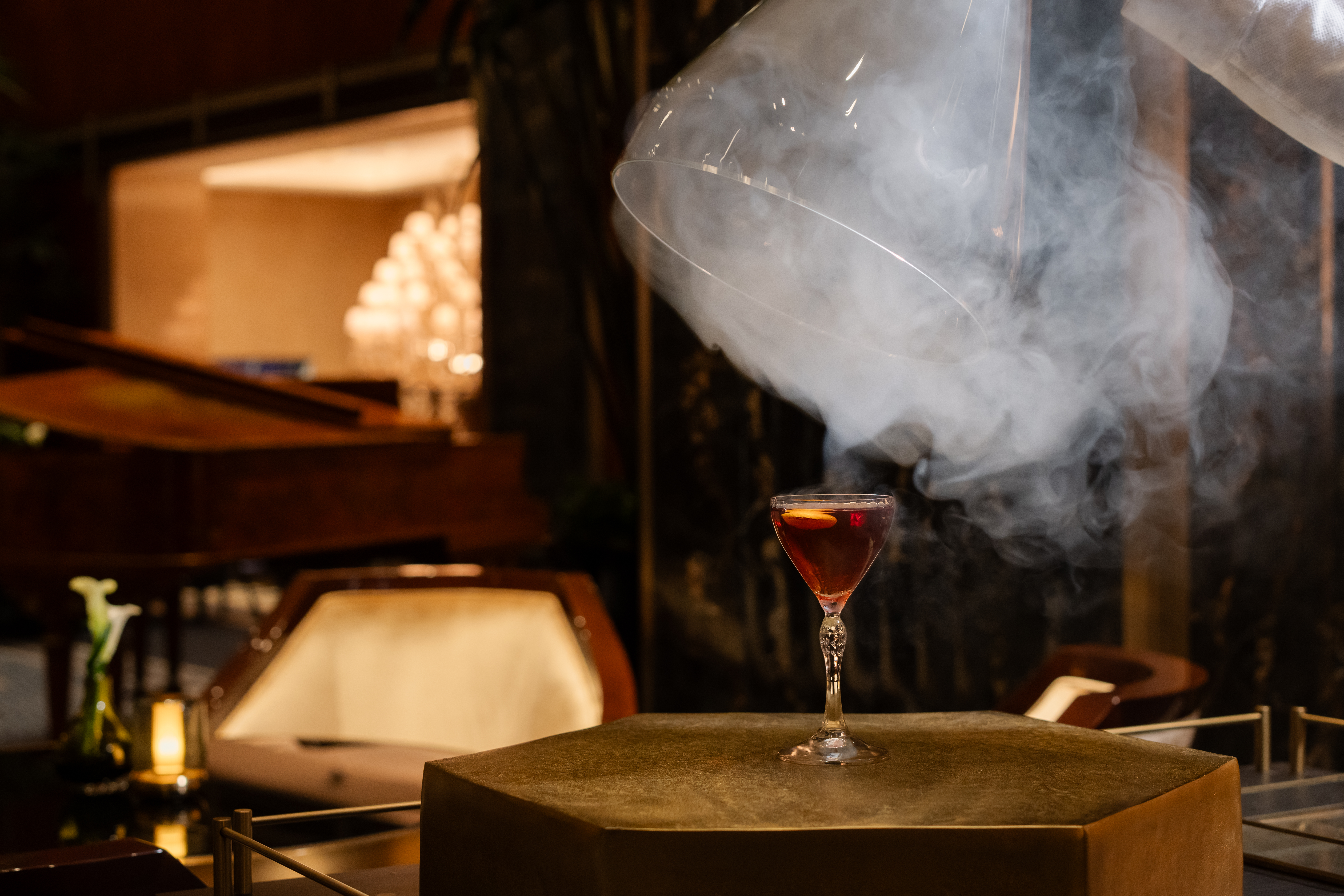 Elegant tableside cocktail service with smoke effects