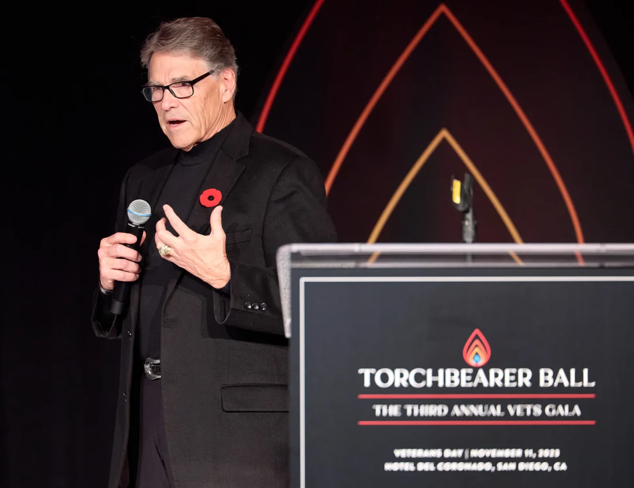 Former Texas Governor Rick Perry speaking on stage at the 2023 VETS Torchbearer Ball