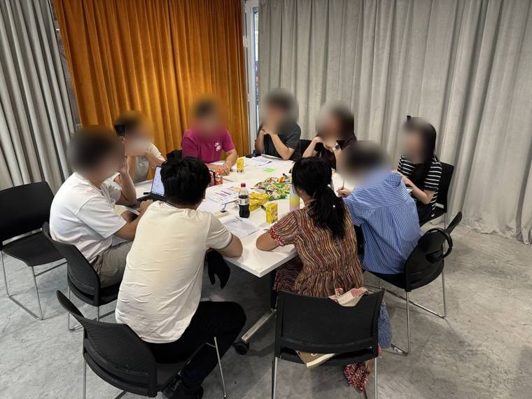 Workshop participants in a discussion around a table