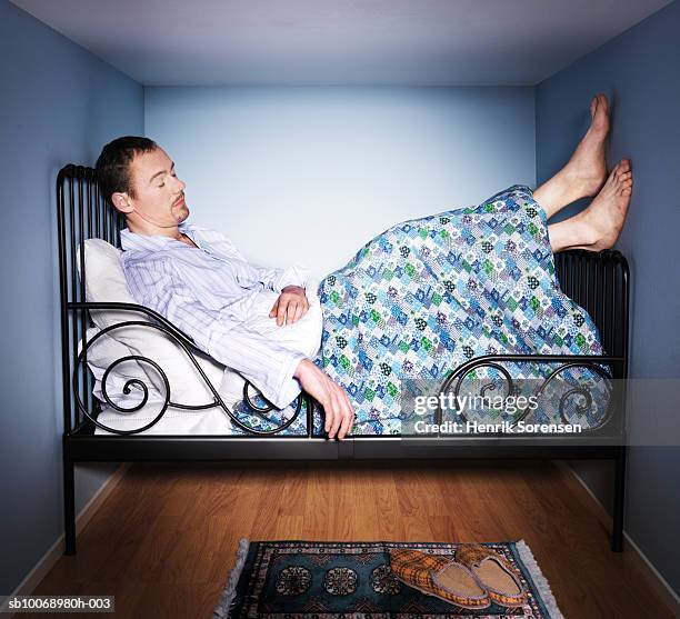 man-sleeping-in-small-bed-room-side-view.jpg