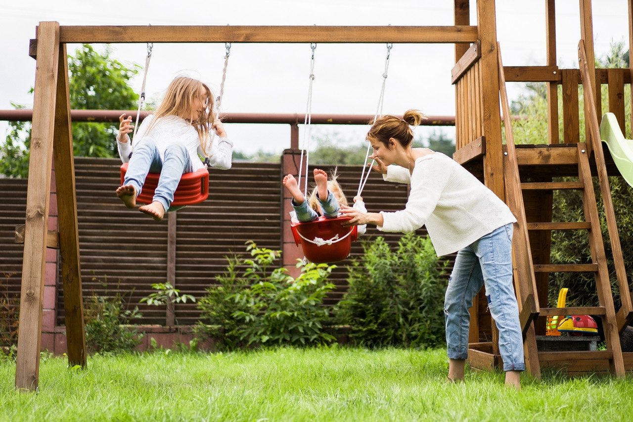 children swing girls sisters swinging swing yard summer fun