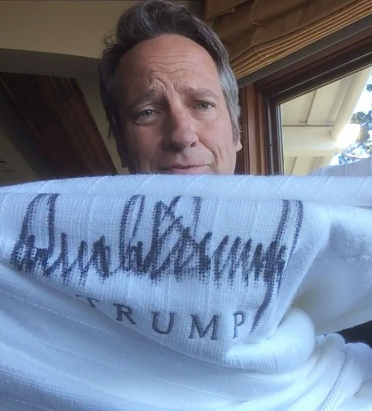 Mark Rowe not only holds Trump's gown but it has his signature and name which was auctioned.