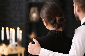 couple grieving at funeral