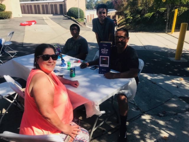 Attendees relax in the shade at Diablo Mini Storage.