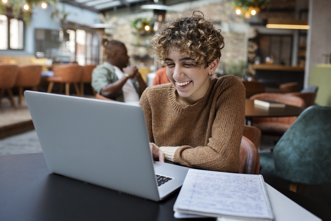 medium shot woman reading coffee shop