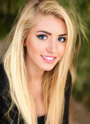Chanel Cazzaniga, a stunning beautiful young blonde lady with striking blue eyes, smiling