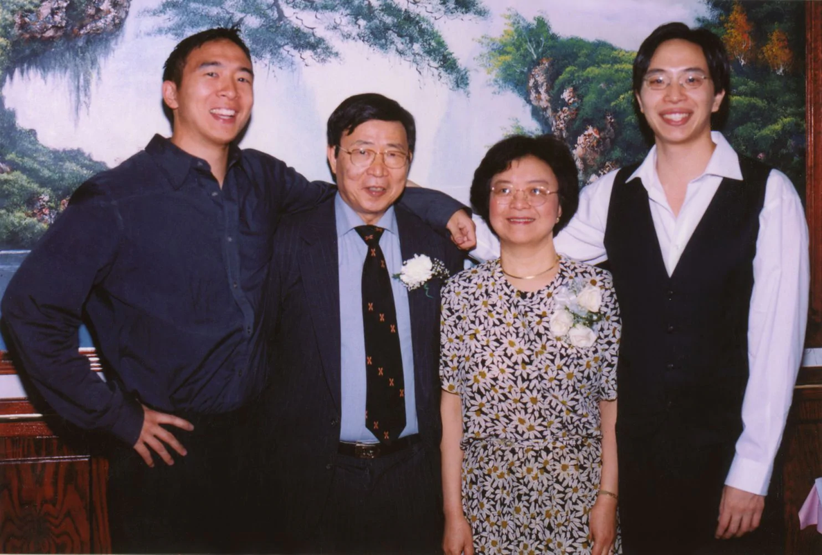 Yang left poses with his father mother and brother at his father's retirement party in 2000