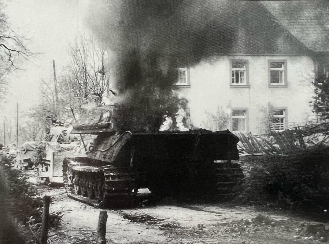 A burning Tiger II (with pre production turret!!)of Schwere Panzer Abteilung 506 blocks the road in 