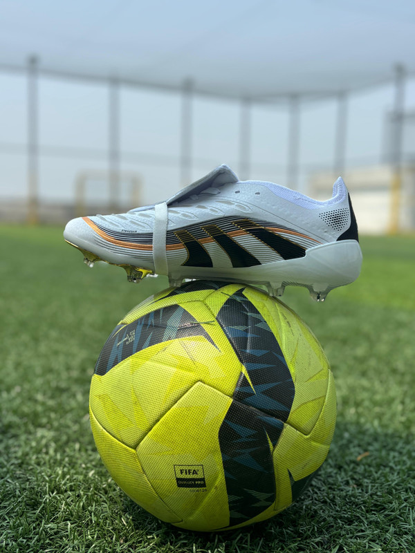 An aerial shot of a green football stadium at sunset.