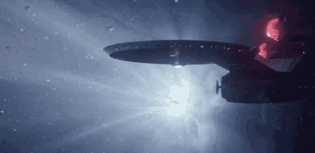 a gif of the USS Enterprise moving through an asteroid field